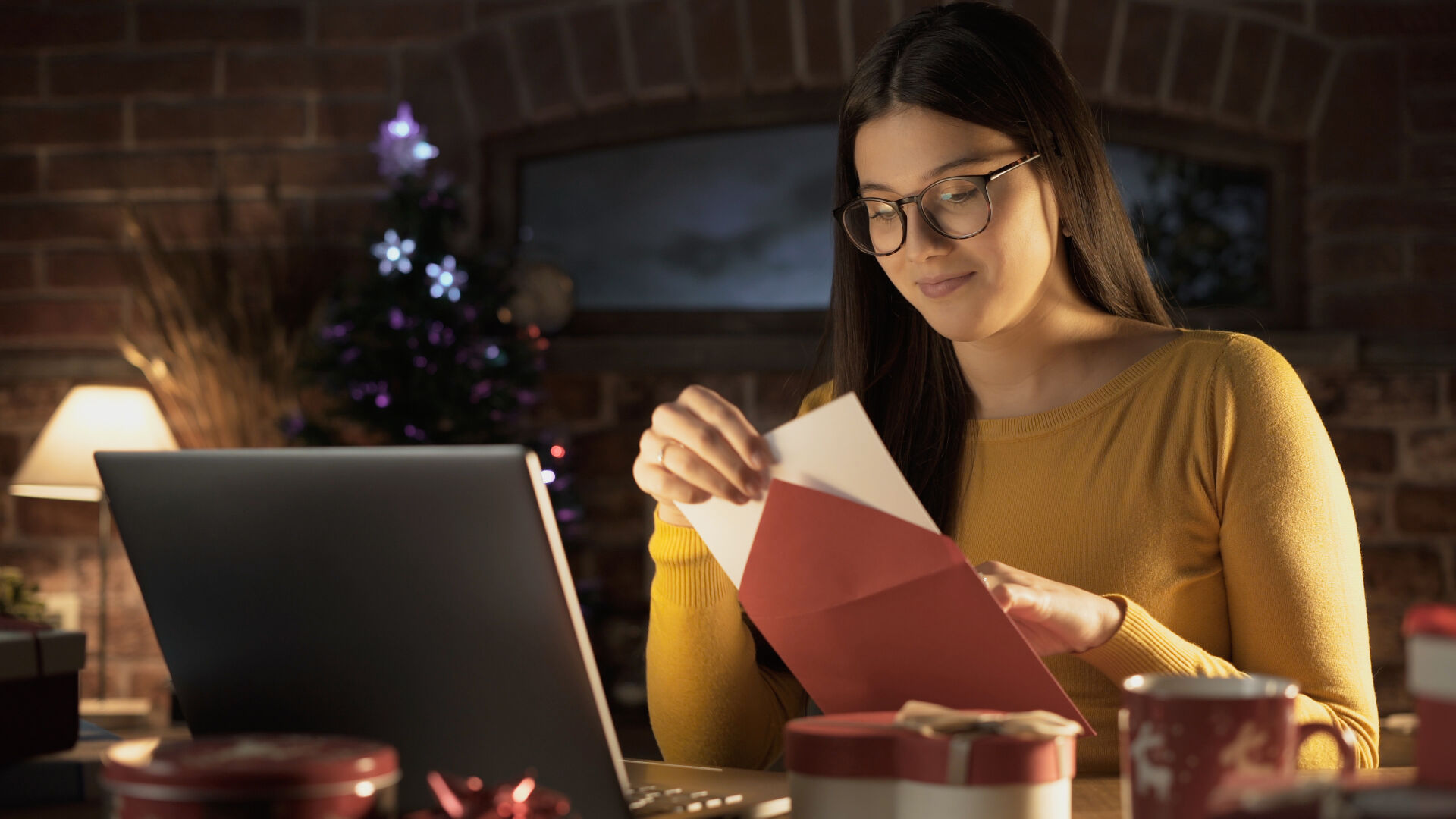 Young woman holding an envelope with a Christmas card